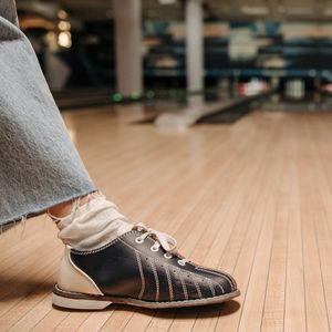 Close-up of athletic shoes on a wooden floor.